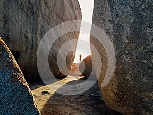 Person Standing in Gap of Remarkable Rocks