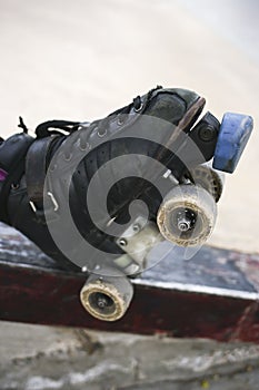 person standing on a metal railing with their skates on