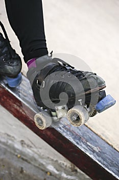 person standing on a metal railing with their skates on