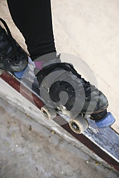 person standing on a metal railing with their skates on