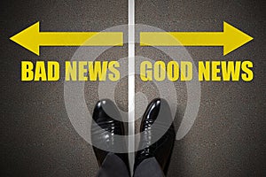 Person Standing Near Arrows With Bad And Good News Options