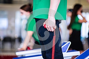 Person standing near swimming pool and keeping time at finish line