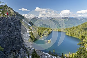 Person Standing over a Cliff overlooking a beautiful landscape in the pacific northwest