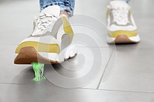 Person stepping into chewing gum on floor, closeup. Space for text