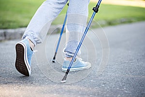 Person stepping slowly forward with help of sticks