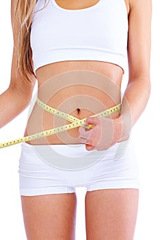 Person, studio and waistline for measuring, health and wellness with diet and weight loss. Woman, abdomen and commitment