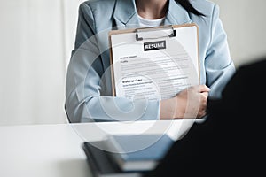 Person submitting resume to interview for a job with a company, Person attending a job interview with a manager to be recruited to