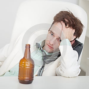 Person suffers from hangover sitting at a table