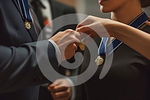 person in suit pinning a medal on a winners chest