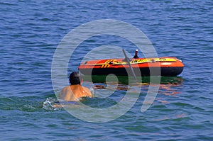 Person swimming around boat