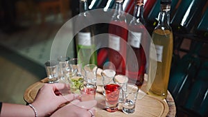 person take colorful alcohol liquor, vermouth or tincture drink in glass