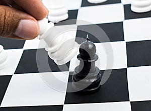 A person taking a black pawn with his own white pawn in a normal chess game