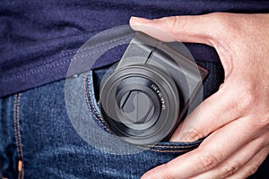 Person taking out a pocket camera out of pocket