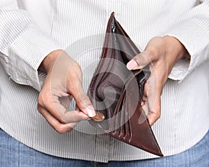 Person taking a penny from wallet - Bankruptcy