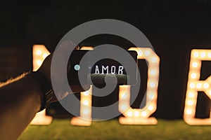 Person taking a photo of Amor with lights