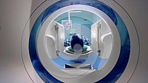 A person in a tomographic scanner. Tomograph, Patient on magnetic resonance imaging.