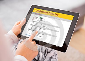 Person tracking shipment on tablet photo