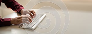 Person typing on a computer keyboard, businessman is working in a startup company's office, he is typing messages to his