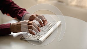 Person typing on a computer keyboard, businessman is working in a startup company's office, he is typing messages to his