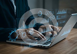 Person Typing with Data Visualization on Laptop