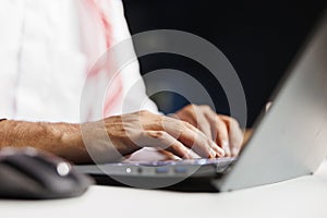 Person typing on a digital laptop