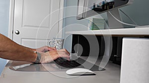 Person typing on keyboard, working from home on computer, closeup side truck