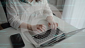 A person coding on a laptop with programming language displayed on screen, showcasing technology and innovation in a