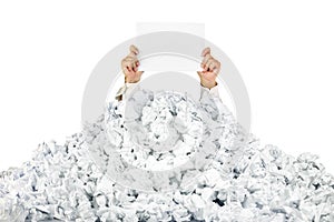 Person under crumpled pile of papers with a blank