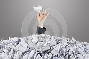 Person under pile of documents