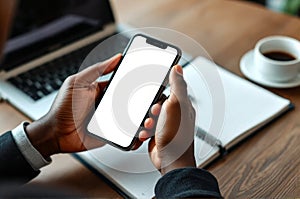 Person Using AI Assistant on Smartphone While Taking Notes at a Workspace