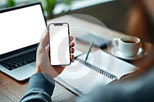 Person Using AI Assistant on Smartphone While Taking Notes at a Workspace