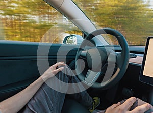 Person using a car in autopilot mode photo