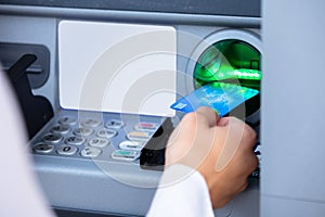 Person Using Card To Withdraw Money From ATM Machine