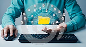 Person using computer mouse and keyboard with digital file folder network technology