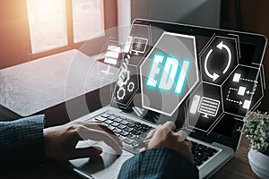 Person using computer on office desk with virtual screen electronic data interchange icon