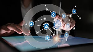 Person using a digital tablet with interactive data visualization and technology icons representing innovation and