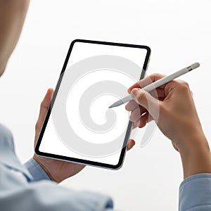 Person using digital tablet with stylus for creative work