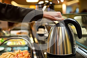 person using electric kettle at a selfservice hotel breakfast area