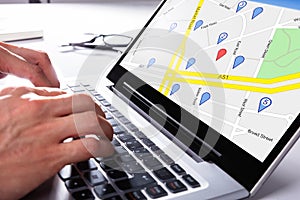 Person Using Gps Map On Laptop