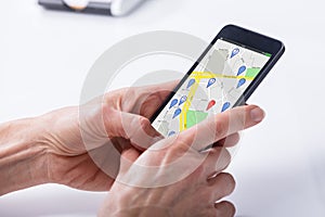 Person Using GPS Navigation Map On Mobile Phone