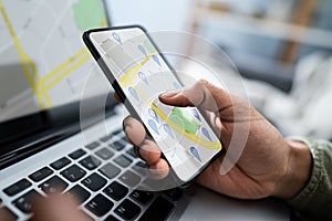 Person Using GPS Navigation Map On Mobile Phone