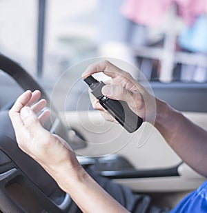 A person is using hand sanitizer sprayer