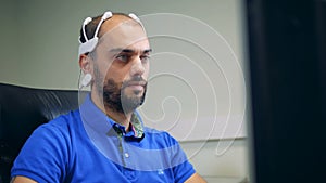 A person using head sensors to check brainwork, close up.