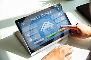 Person using home control system on laptop