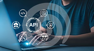 Person using laptop with API connection diagram application programming interface