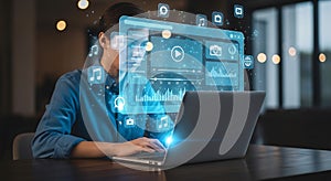 A person using a laptop with augmented reality interfaces and data visualizations