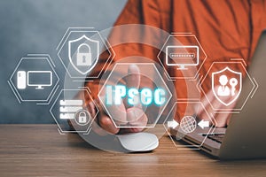 Person using laptop computer and hand touching IPsec icon on virtual screen