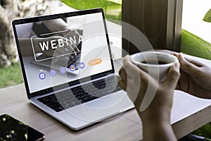 Person using a laptop computer for online training webinar. E-learning browsing connection and cloud online technology webcast