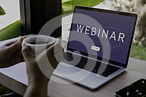 Person using a laptop computer for online training webinar. E-learning browsing connection and cloud online technology webcast