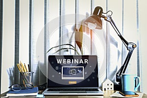 Person using a laptop computer for online training webinars.